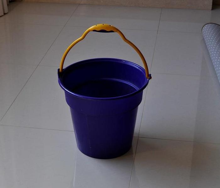 blue bucket on tile floor